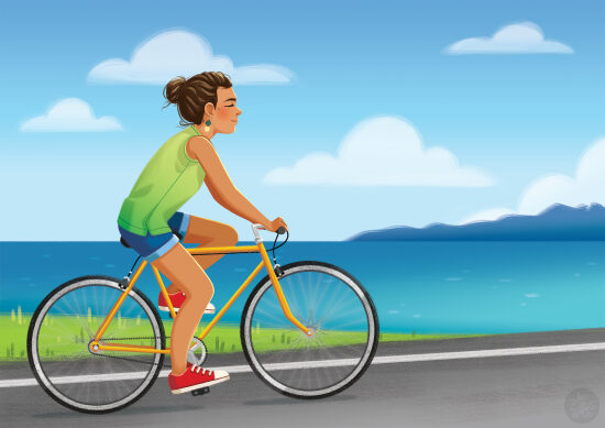 Femme à vélo au bord de la mer